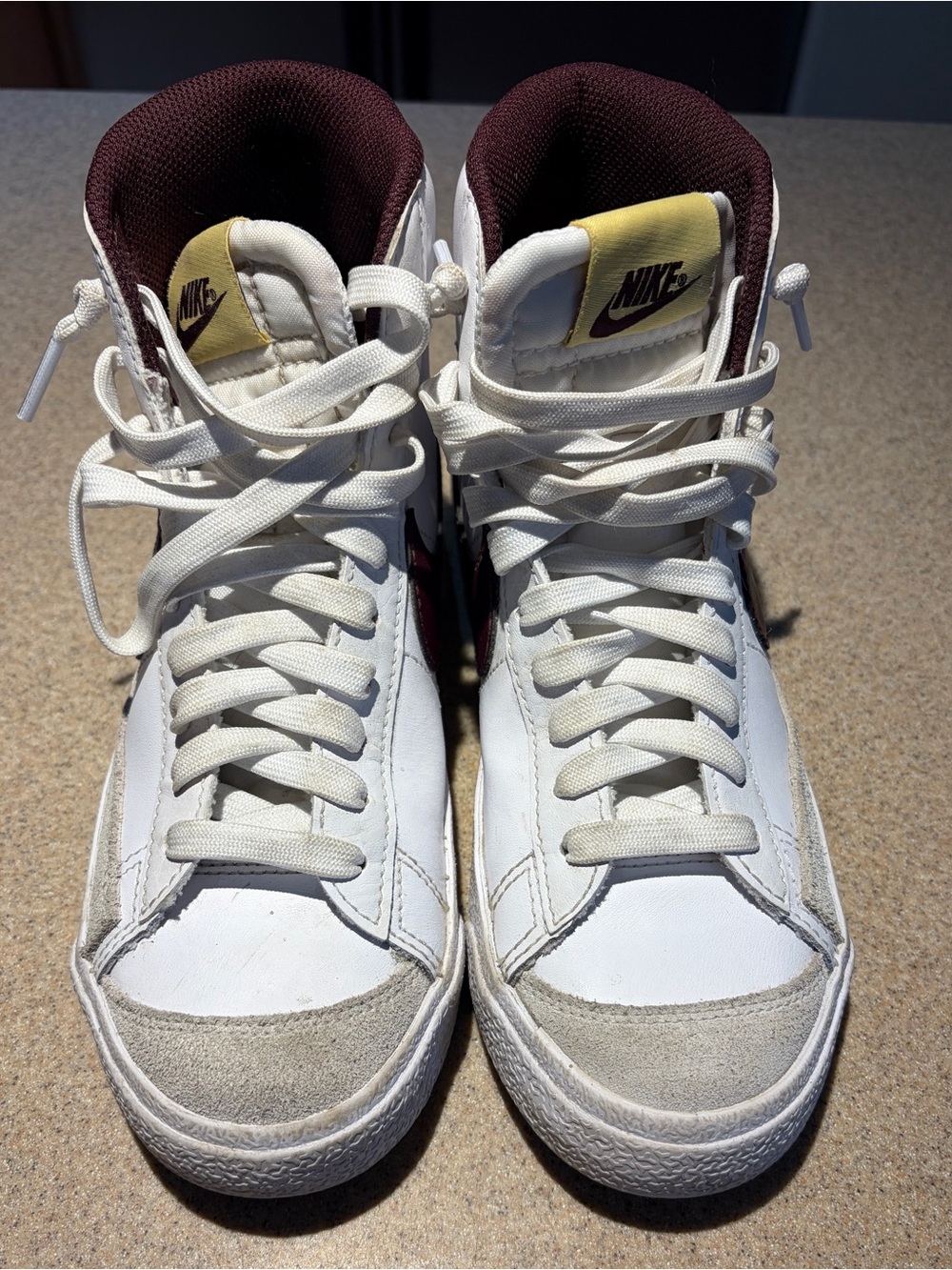Nike White High-Top Sneakers with Maroon Lining and Yellow Tongue Tags